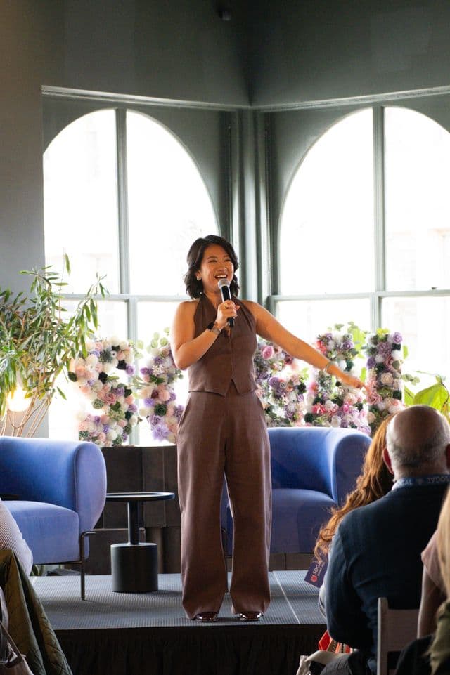 A speaker on stage at the SoGal 2025 summit